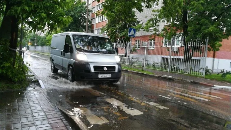 Коммунальщики в Королеве открывают люки канализации для удаления воды с улиц