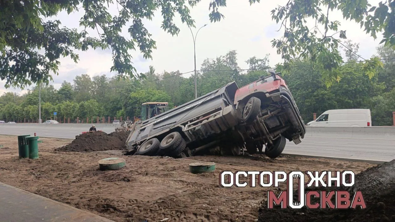 Застрял в текстурах: грузовик почти целиком провалился в яму в Москве